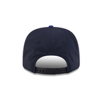 Navy blue snapback cap with adjustable strap and blue button, from revnhaus