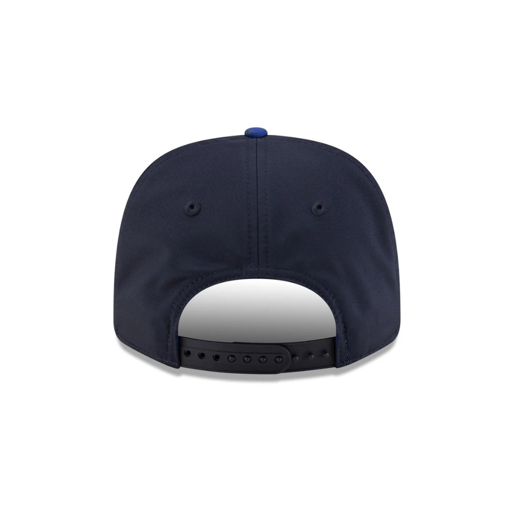 Navy blue snapback cap with adjustable strap and blue button, from revnhaus