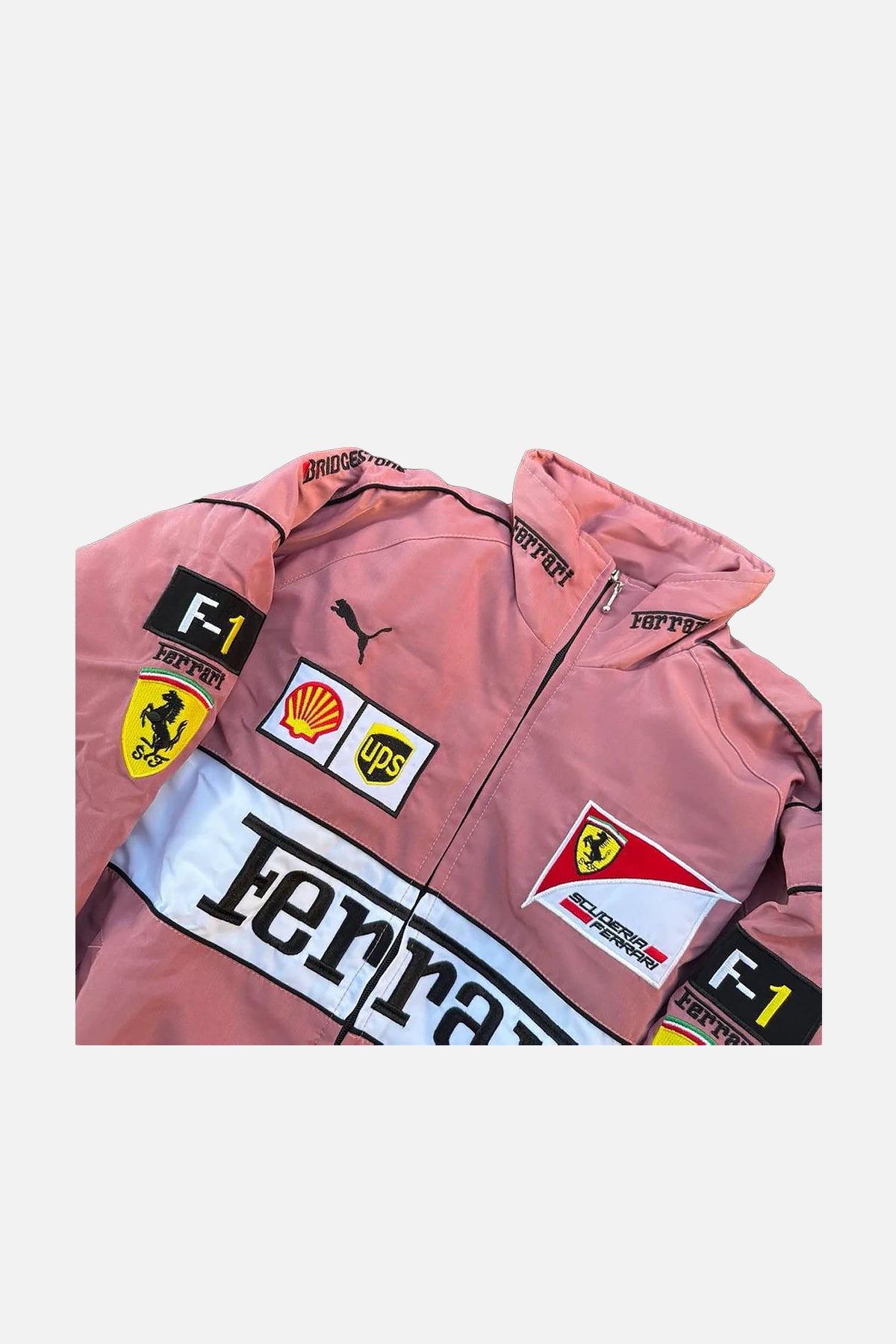 Pink Ferrari F1 racing jacket with Shell, UPS, and Scuderia logos from revnhaus