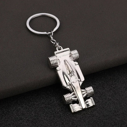 Silver F1 race car keychain with detailed chassis and wheels from revnhaus