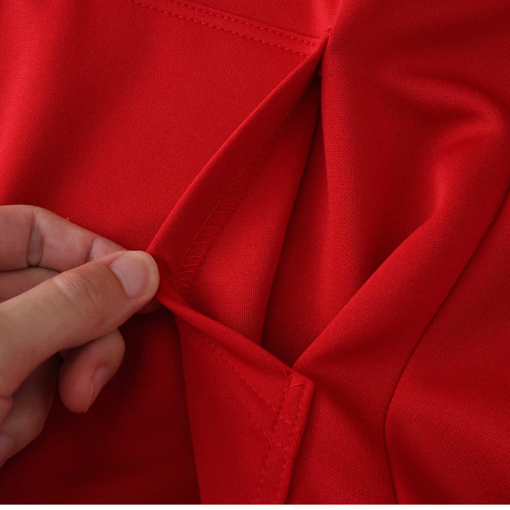 Close-up of red racing jacket fabric and stitching detail from revnhaus