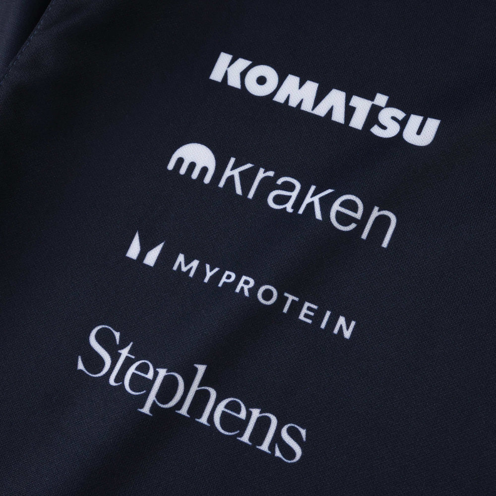 Black motorsport jacket with Komatsu, Kraken, Myprotein, Stephens logos from revnhaus