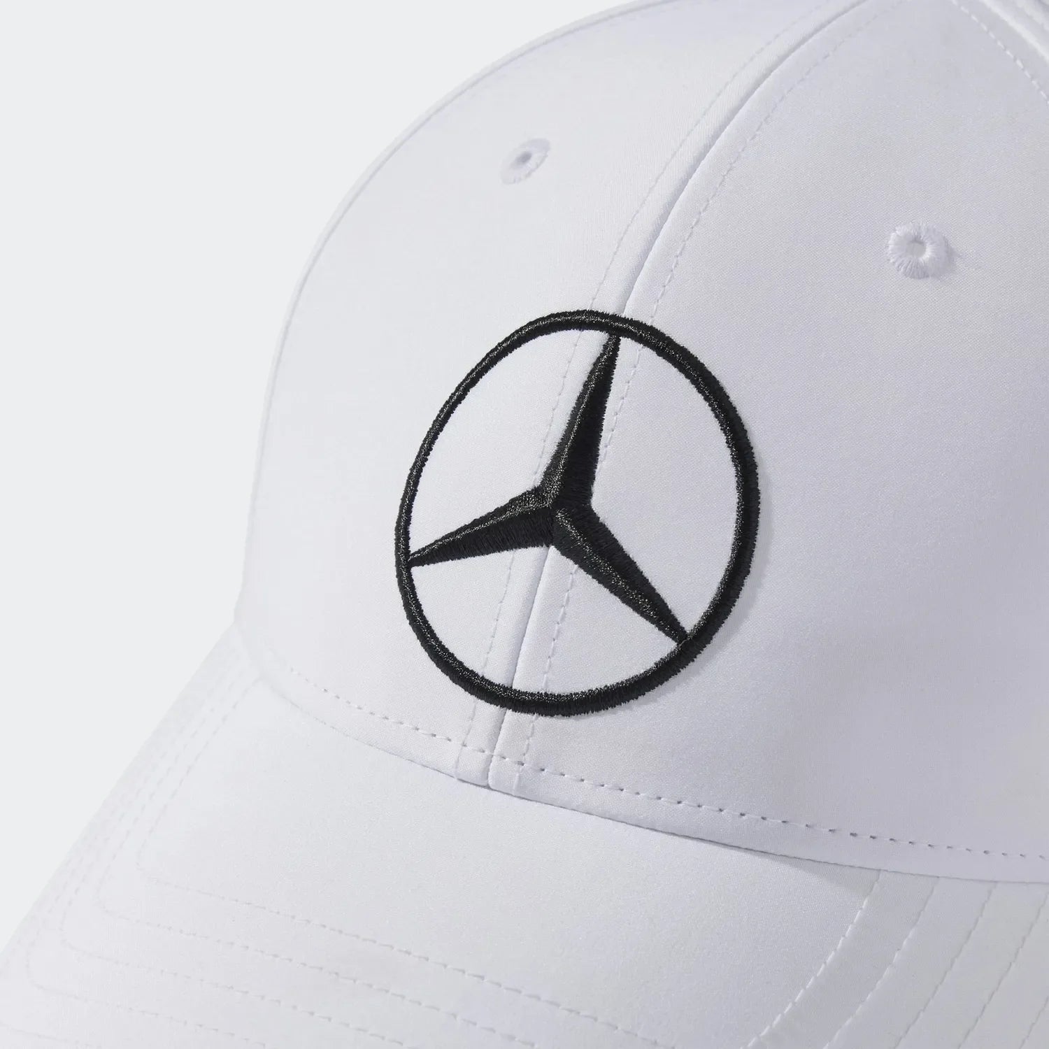 White Mercedes-Benz logo cap with black embroidery, motorsport apparel from revnhaus