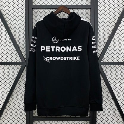 Black Mercedes-AMG Petronas F1 hoodie with CrowdStrike logo, hanging on hanger from revnhaus