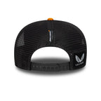 Black McLaren Castore trucker hat with mesh back and orange button, from revnhaus