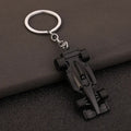 Black F1 race car keychain with silver ring, motorsport collectible from revnhaus