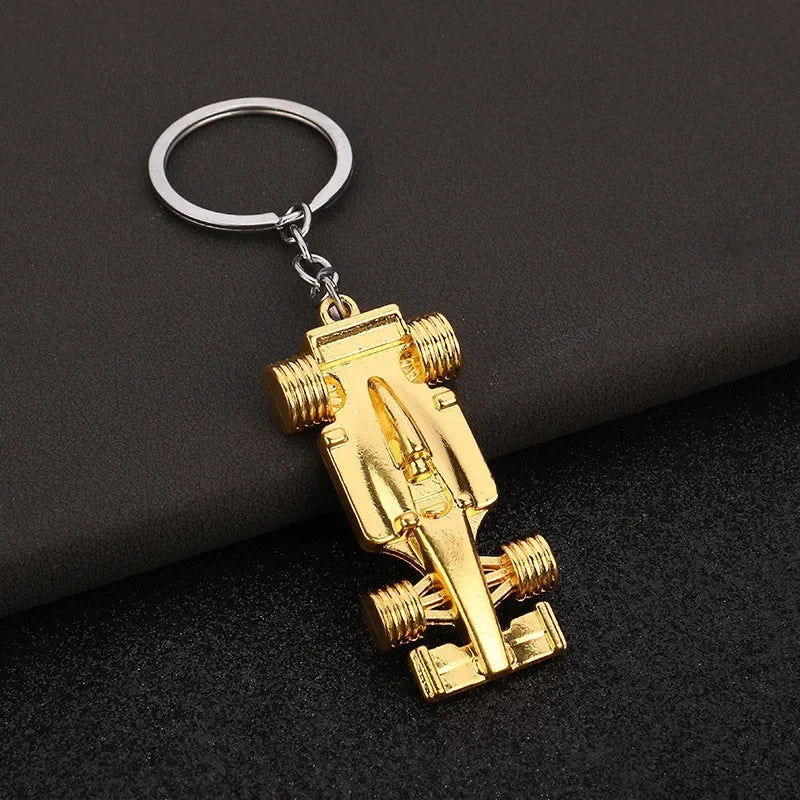 Gold F1 race car keychain with detailed design from revnhaus