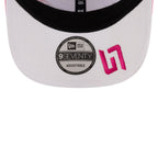 White New Era 9FIFTY adjustable cap with pink logo, motorsport style from revnhaus