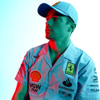 Ferrari F1 team shirt and cap with Shell, Puma, Santander logos under red and blue lighting from revnhaus