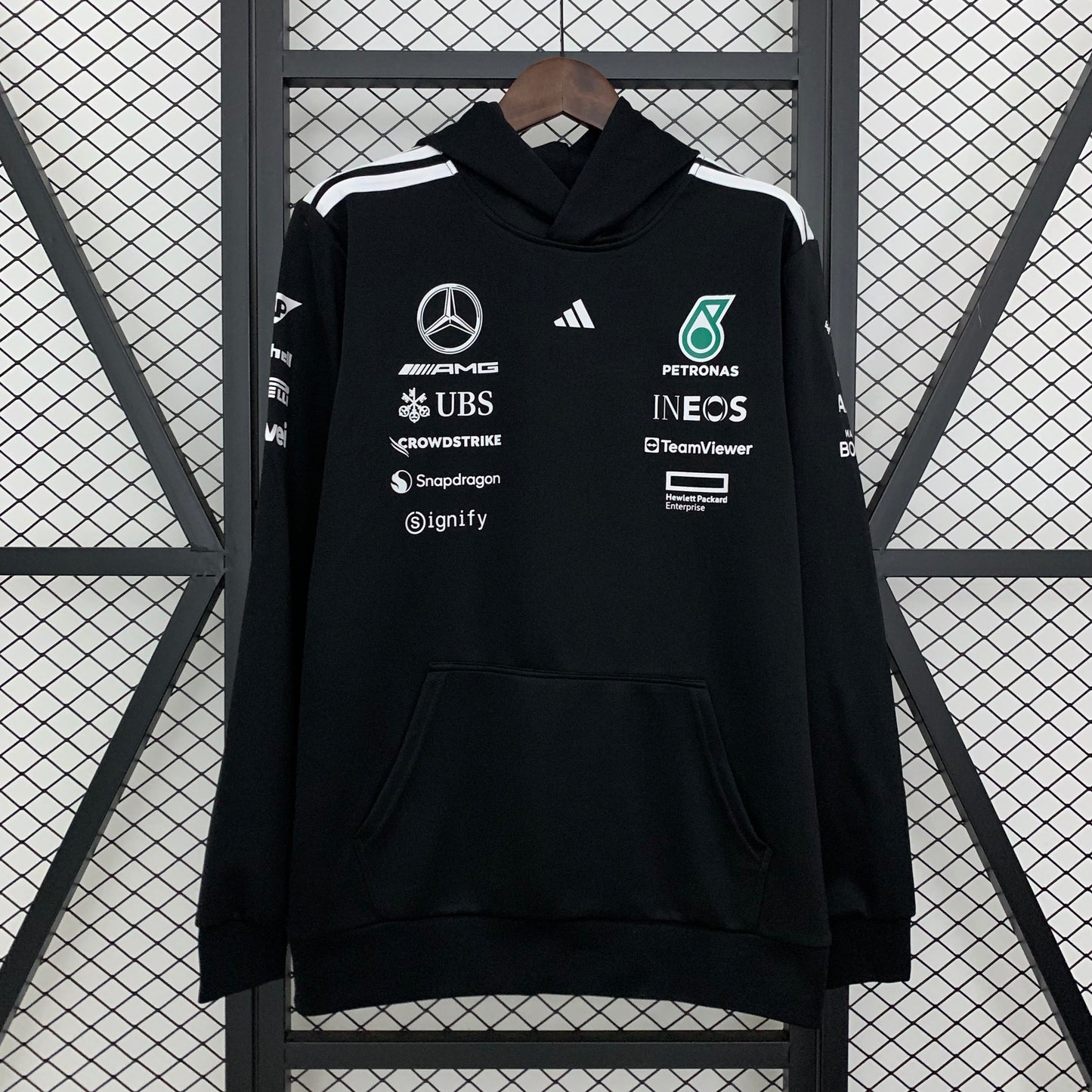 Black F1 team hoodie with sponsor logos, white stripes, and front pocket from revnhaus