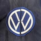 Embroidered VW logo patch on dark racing jacket from revnhaus
