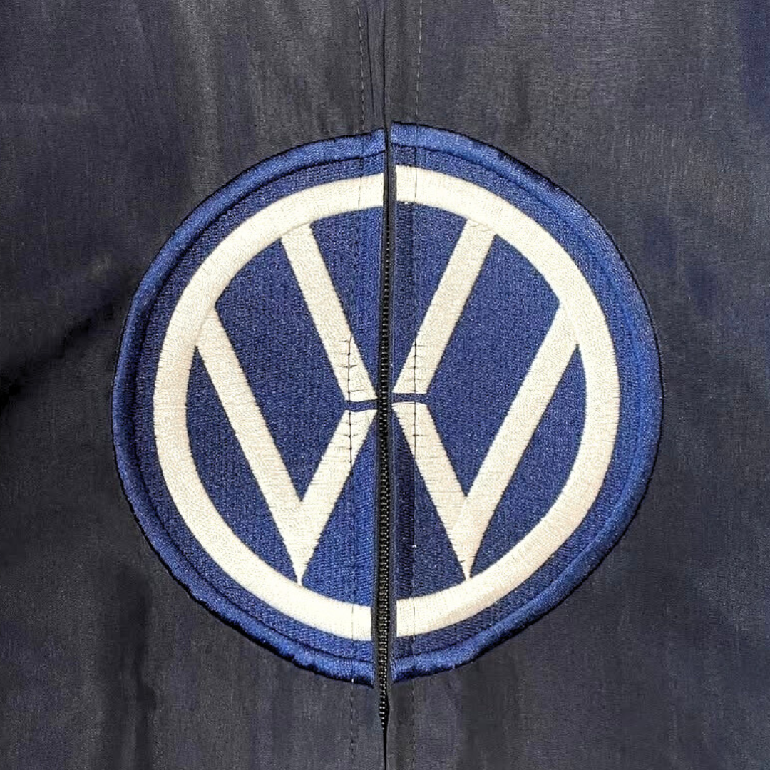 Embroidered VW logo patch on dark racing jacket from revnhaus