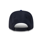 Navy blue snapback cap with adjustable strap and blue button, from revnhaus