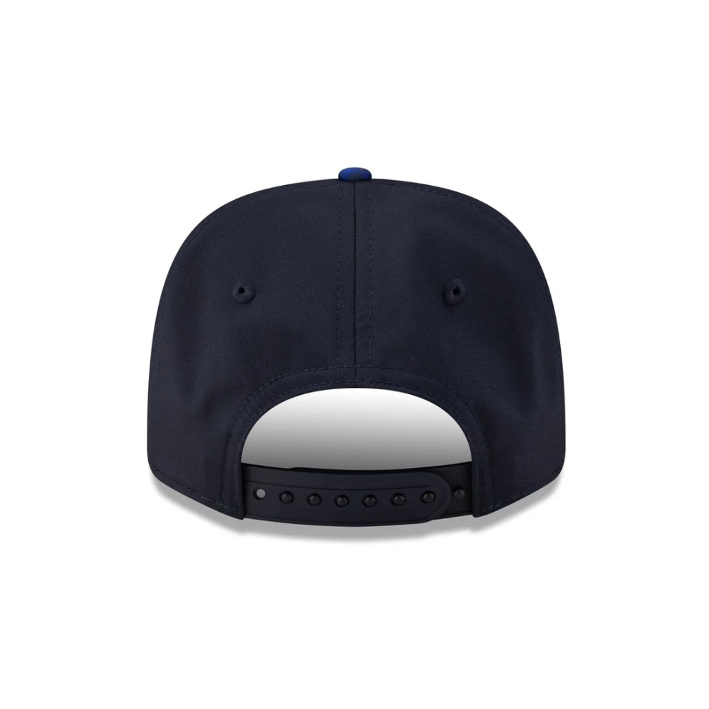 Navy blue snapback cap with adjustable strap and blue button, from revnhaus
