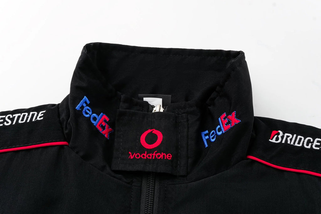 Black F1 racing jacket with FedEx, Vodafone, Bridgestone logos from revnhaus