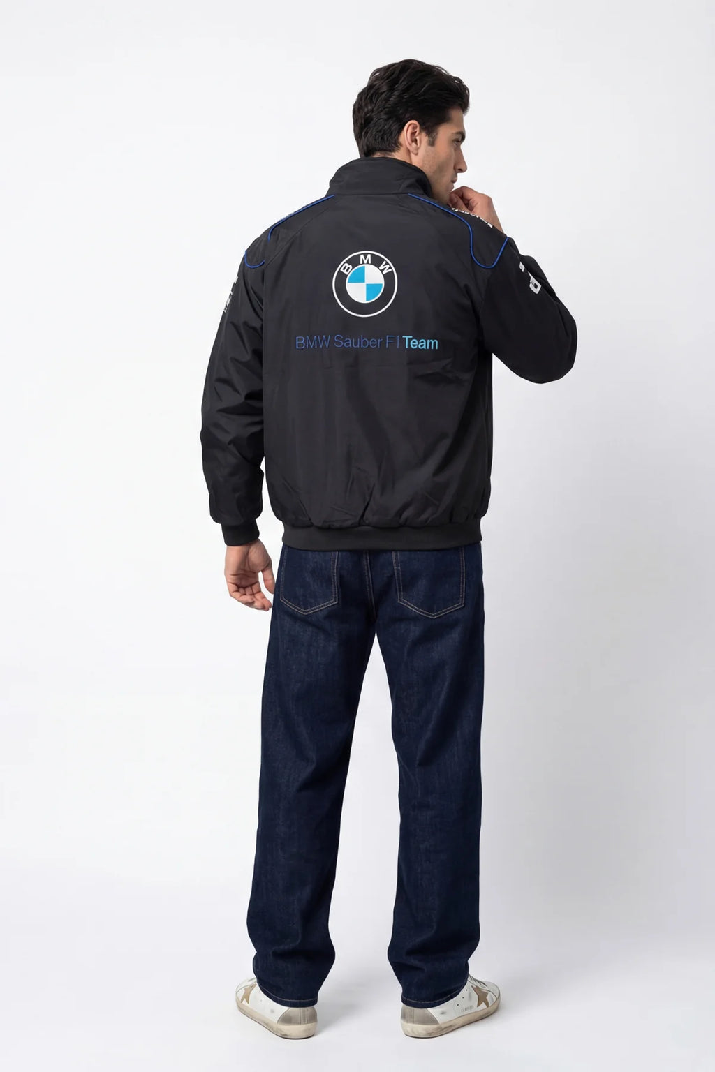 Black BMW Sauber F1 Team jacket with logo, worn by man in jeans, from revnhaus