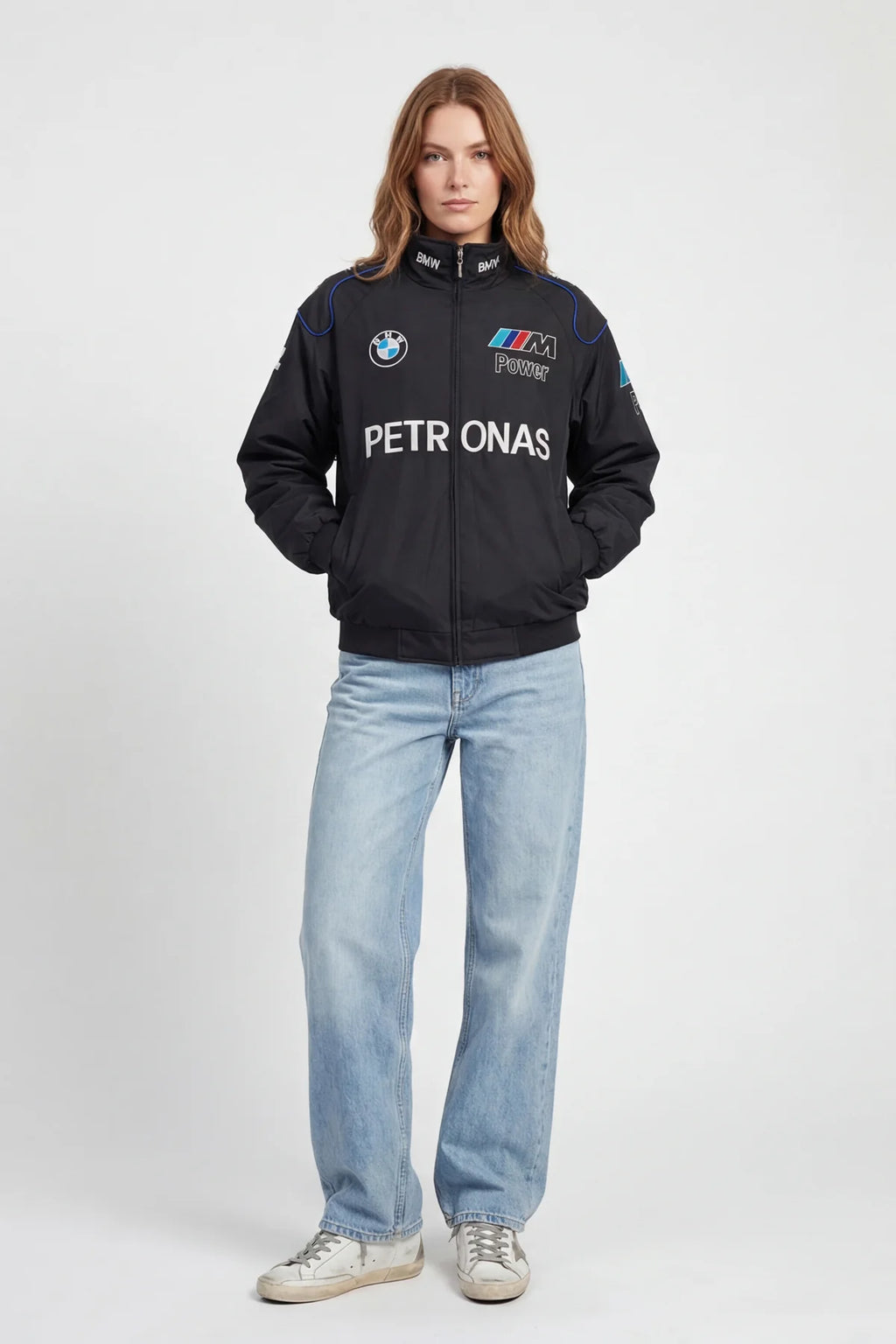 Woman wearing black BMW M Power racing jacket with Petronas logo, styled with light jeans from revnhaus