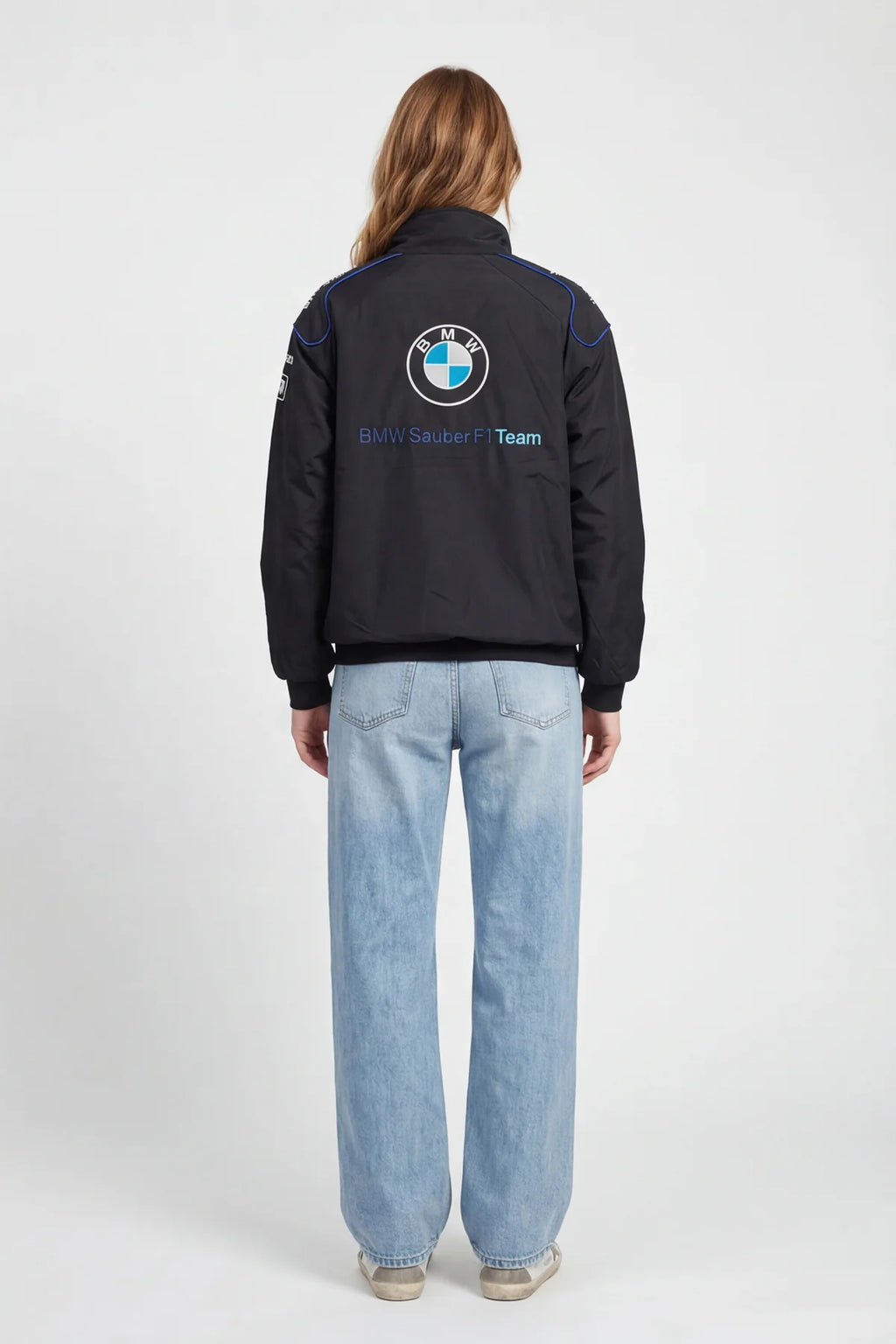 Black BMW Sauber F1 Team jacket with logo, worn with light denim jeans from revnhaus