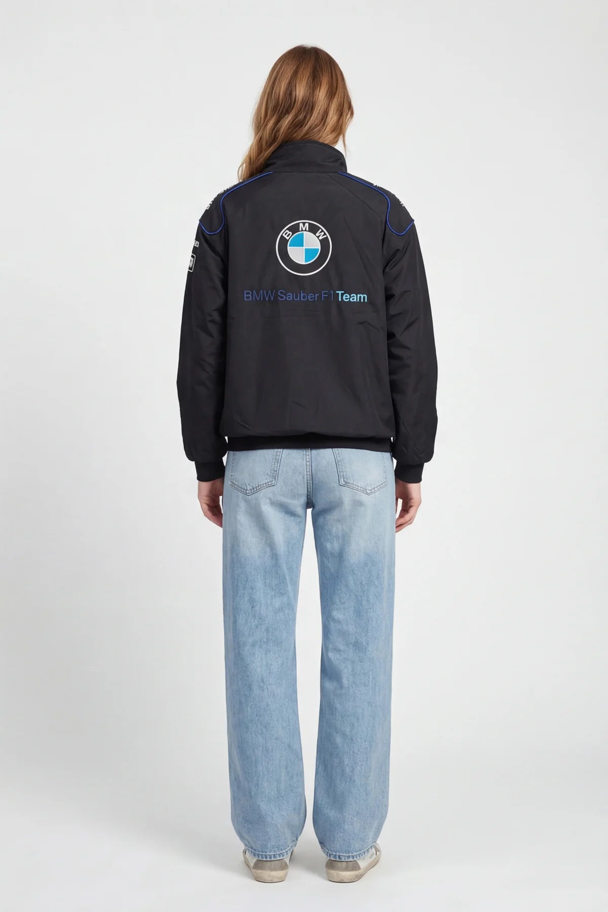 Black BMW Sauber F1 Team jacket with logo, worn with light denim jeans from revnhaus