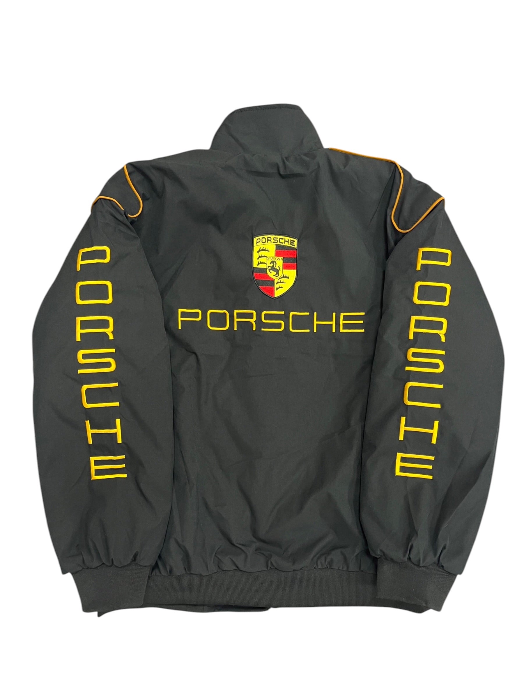 Black Porsche racing jacket with yellow logo and 'MIND' sleeves, from revnhaus