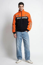 Orange and black Harley-Davidson racing jacket with bold branding, styled with jeans and sneakers from revnhaus