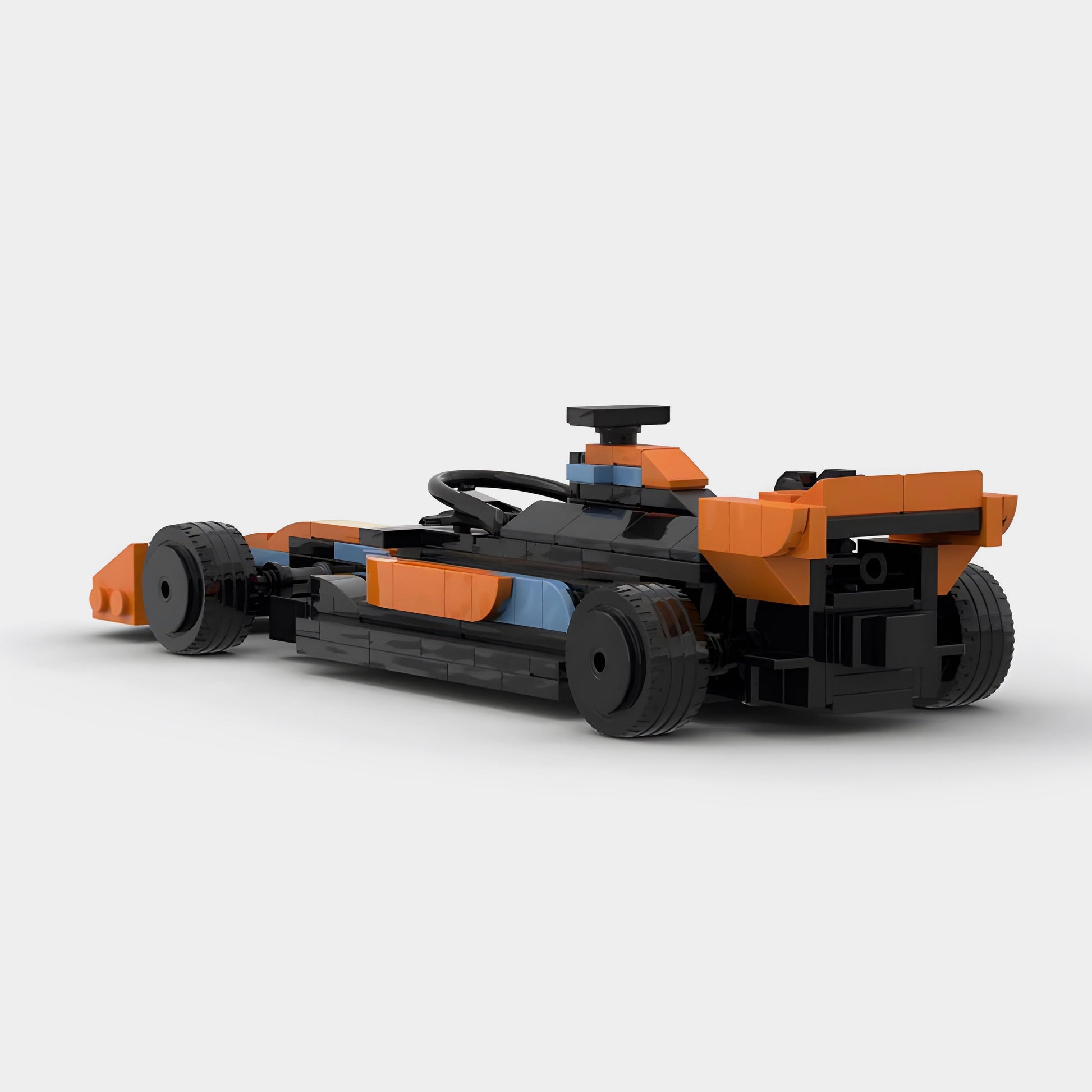 Orange and black LEGO-style F1 race car model with blue accents, from revnhaus