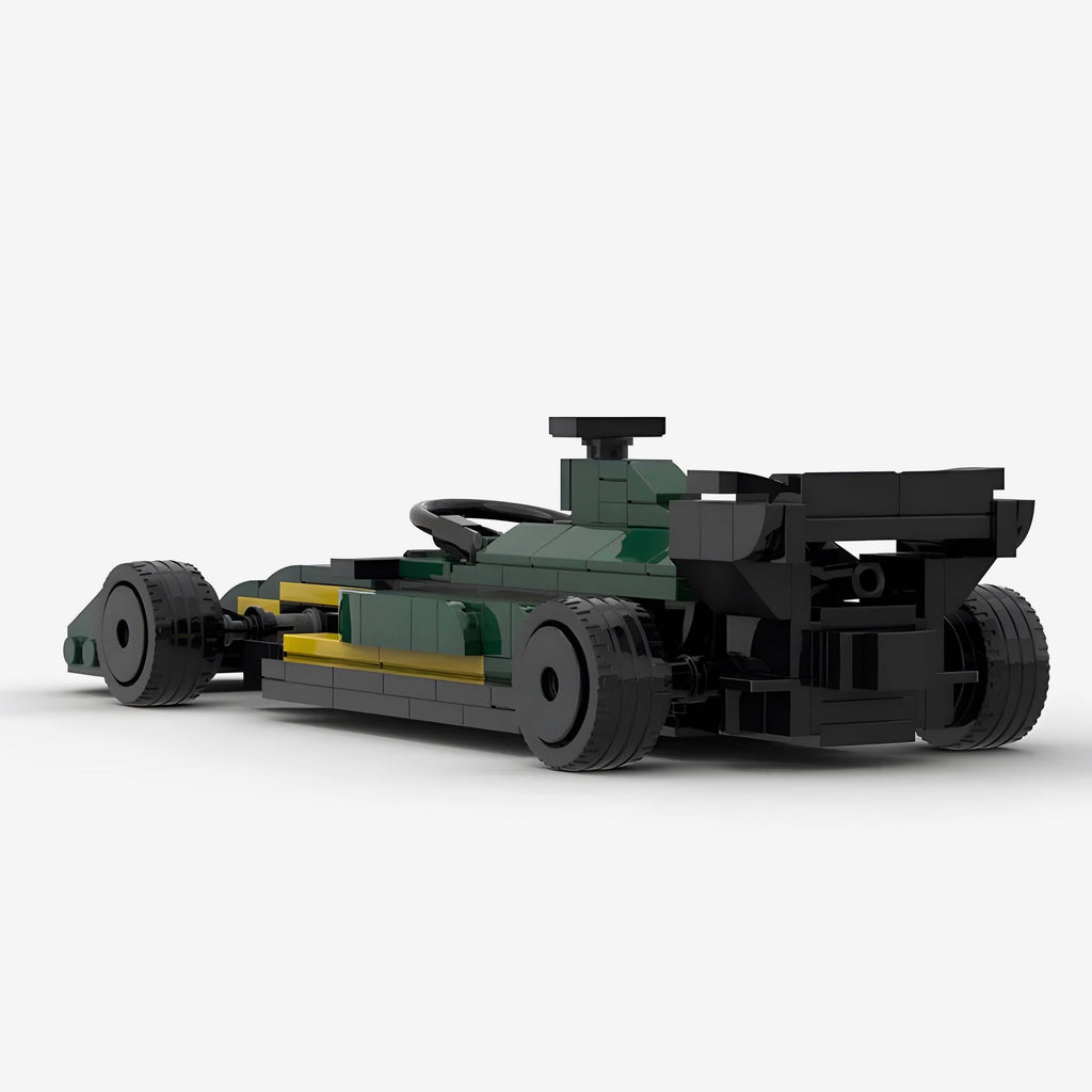 Green and yellow LEGO-style F1 race car model with black tires and rear wing from revnhaus