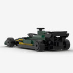 Green and yellow LEGO-style F1 race car model with black tires and rear wing from revnhaus