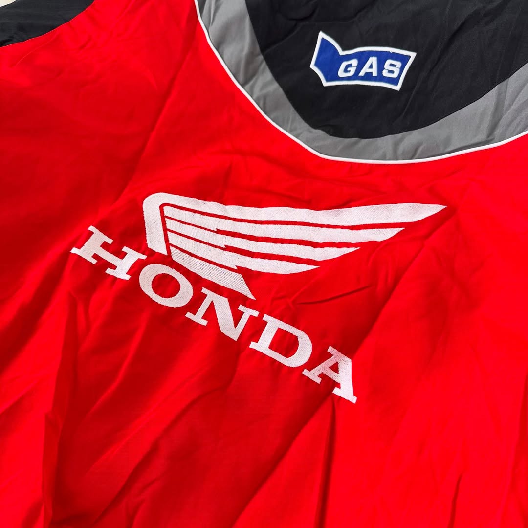 Red Honda racing jacket with white wing logo and GAS patch from revnhaus
