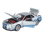 Silver Nissan GT-R die-cast model with blue stripes, open hood & doors, red interior from revnhaus