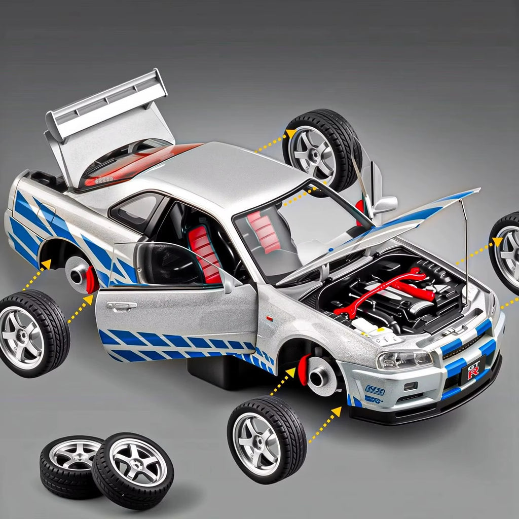 Silver GT-R die-cast model with blue stripes, open hood, and removable wheels from revnhaus