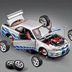 Silver GT-R die-cast model with blue stripes, open hood, and removable wheels from revnhaus