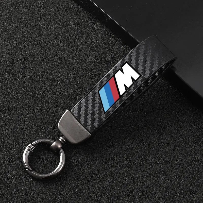 Carbon fiber BMW M keychain with blue and red logo, sleek metal ring from revnhaus