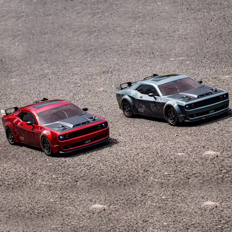 Red and gray RC drift cars on gravel track, detailed die-cast models from revnhaus