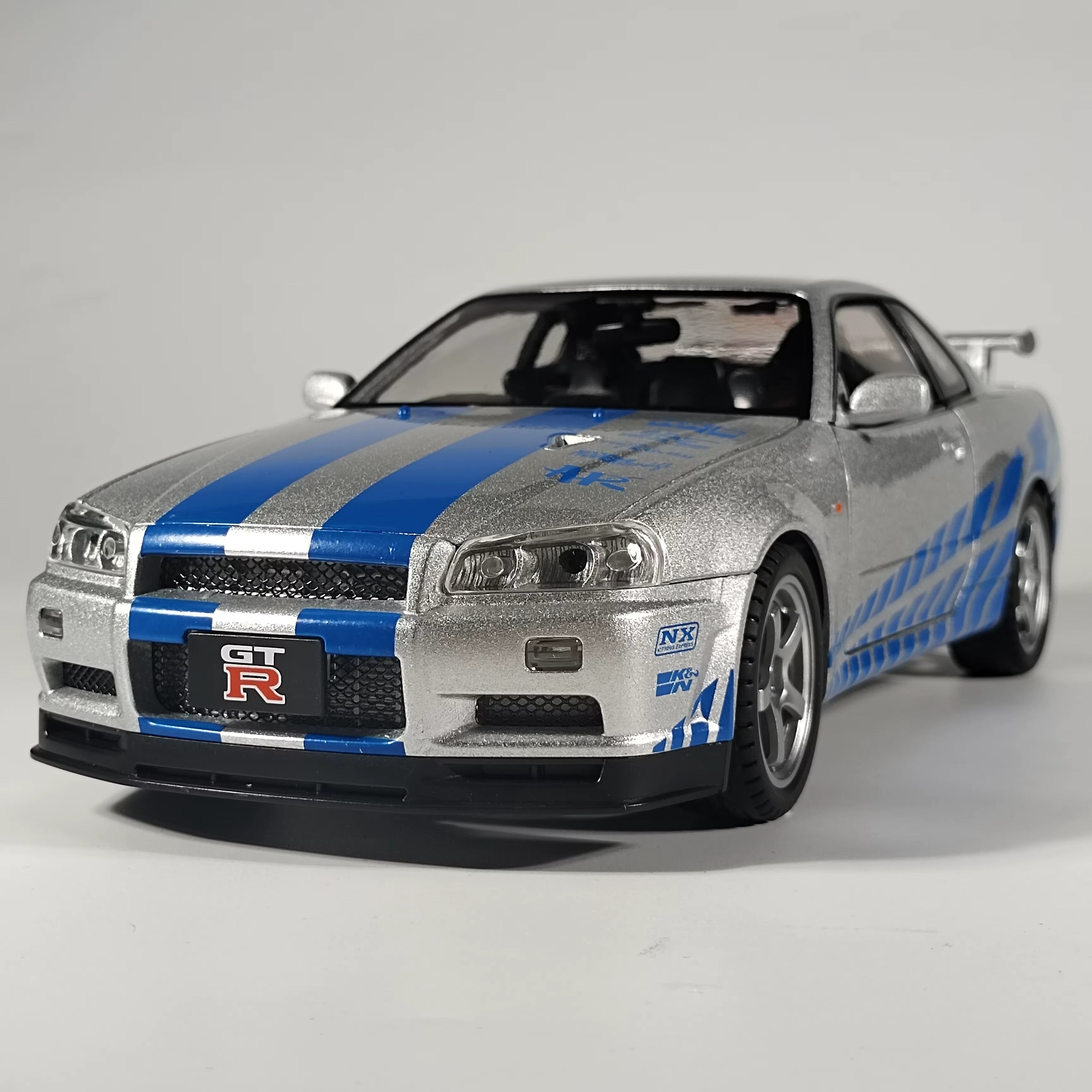 Silver and blue Nissan GT-R die-cast model car with racing decals from revnhaus
