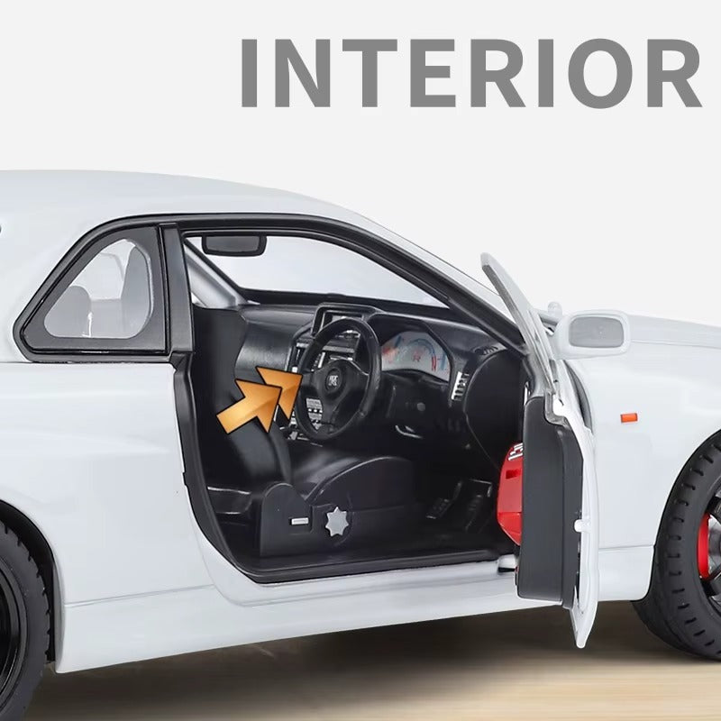 White die-cast car interior with black seats and steering wheel, door open, from revnhaus