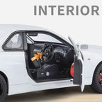 White die-cast car interior with black seats and steering wheel, door open, from revnhaus
