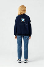 BMW Sauber F1 Team navy jacket with logo, worn with jeans and sneakers from revnhaus