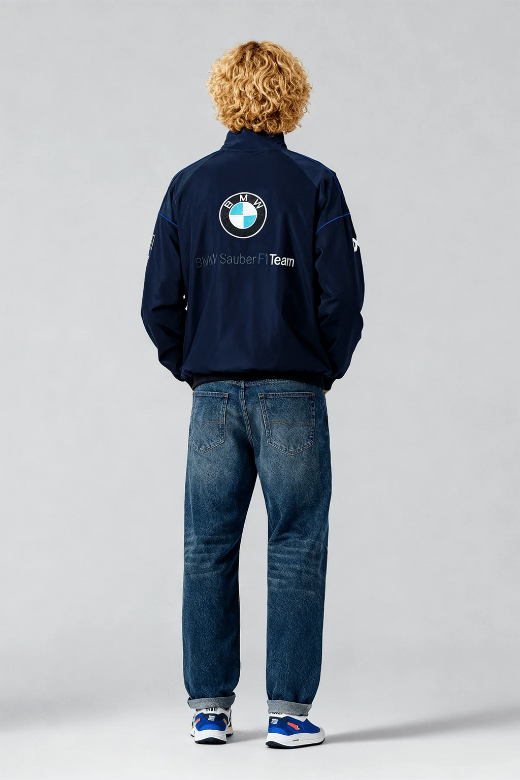 BMW Sauber F1 Team navy jacket with logo, worn with jeans and sneakers from revnhaus
