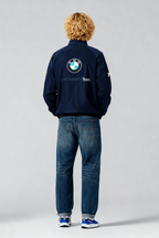 BMW Sauber F1 Team navy jacket with logo, worn with jeans and sneakers from revnhaus