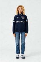 Woman wearing navy BMW M Power Petronas racing jacket with jeans and sneakers from revnhaus
