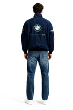 BMW Sauber F1 Team navy jacket with logo, worn with jeans and white sneakers from revnhaus