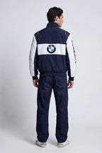 Man wearing navy and white BMW racing jacket with Formula 1 text on sleeves from revnhaus