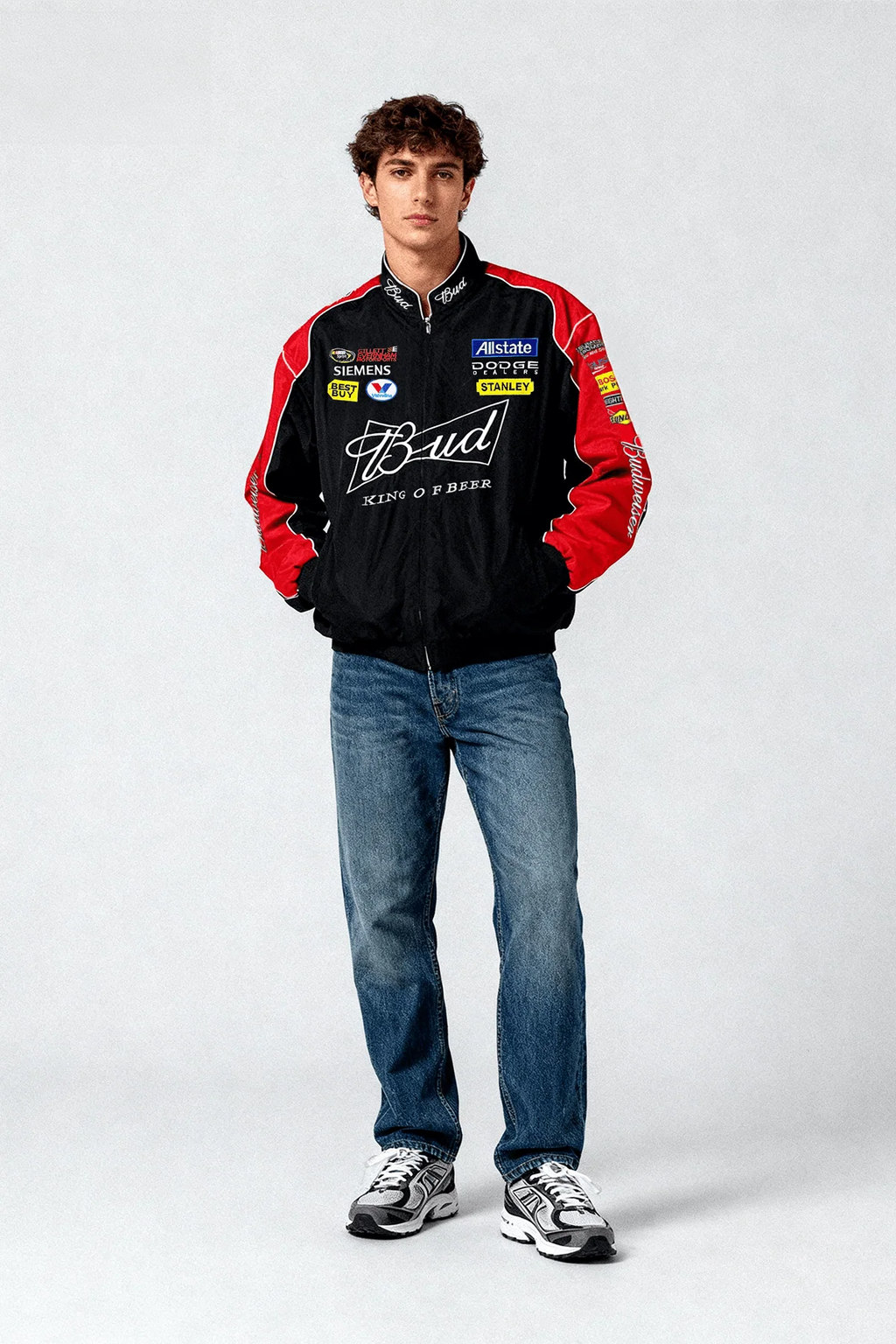 Black and red Bud racing jacket with sponsor logos, worn with jeans and sneakers from revnhaus