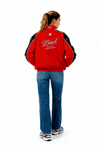 Red Bud racing jacket with black sleeves and #9 logo, worn by woman in jeans from revnhaus