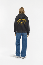 Black hoodie with vintage Camel Racing Service graphic on back, worn with jeans from revnhaus