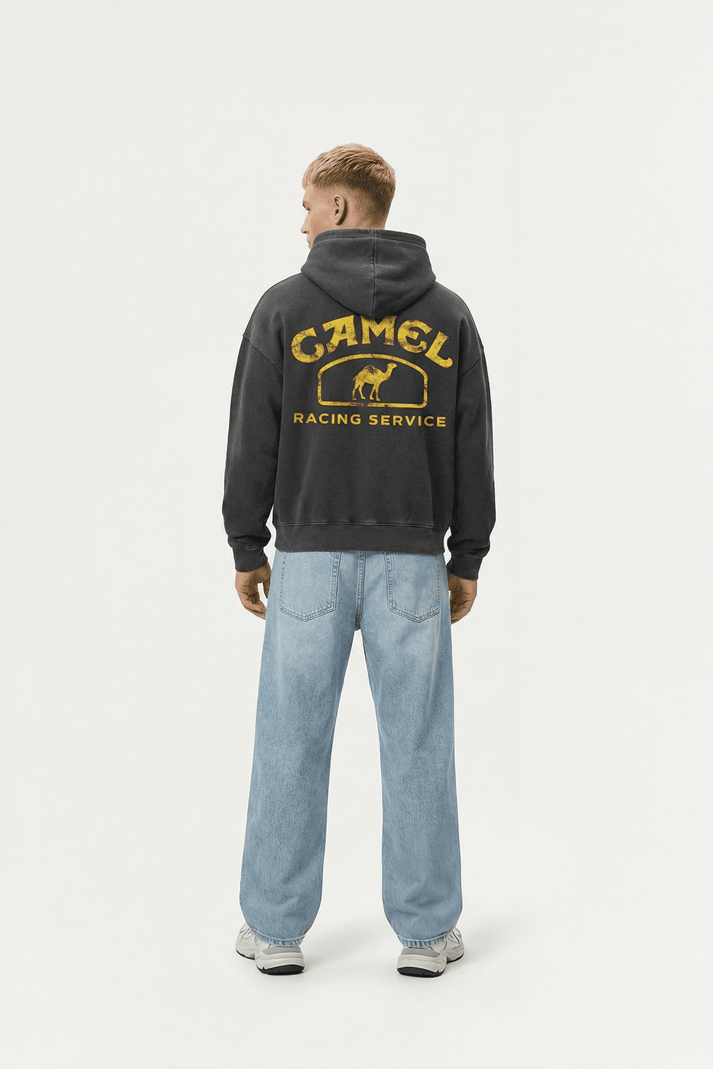 Black hoodie with vintage Camel Racing Service graphic, worn with blue jeans from revnhaus