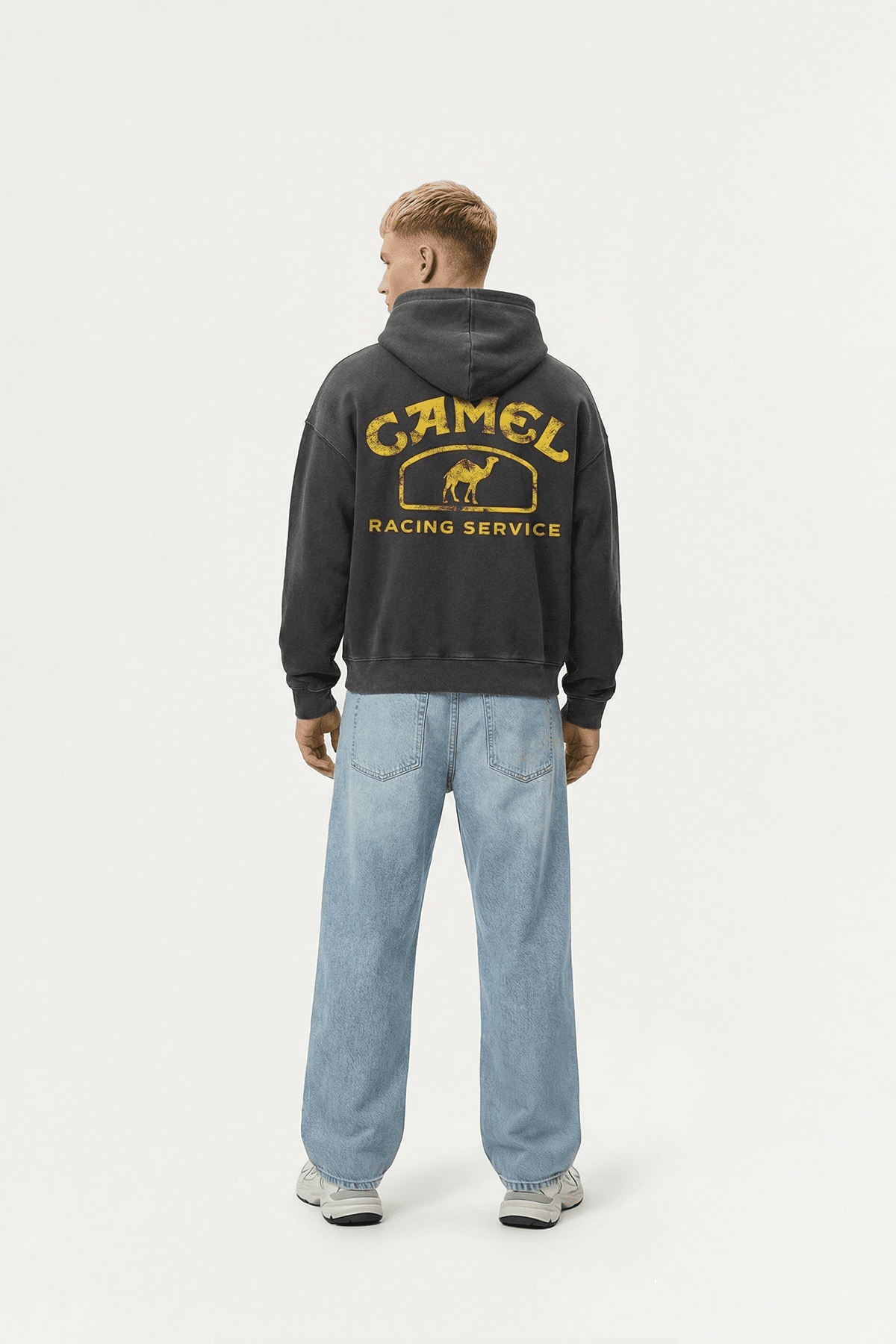 Black hoodie with vintage Camel Racing Service graphic, worn with blue jeans from revnhaus