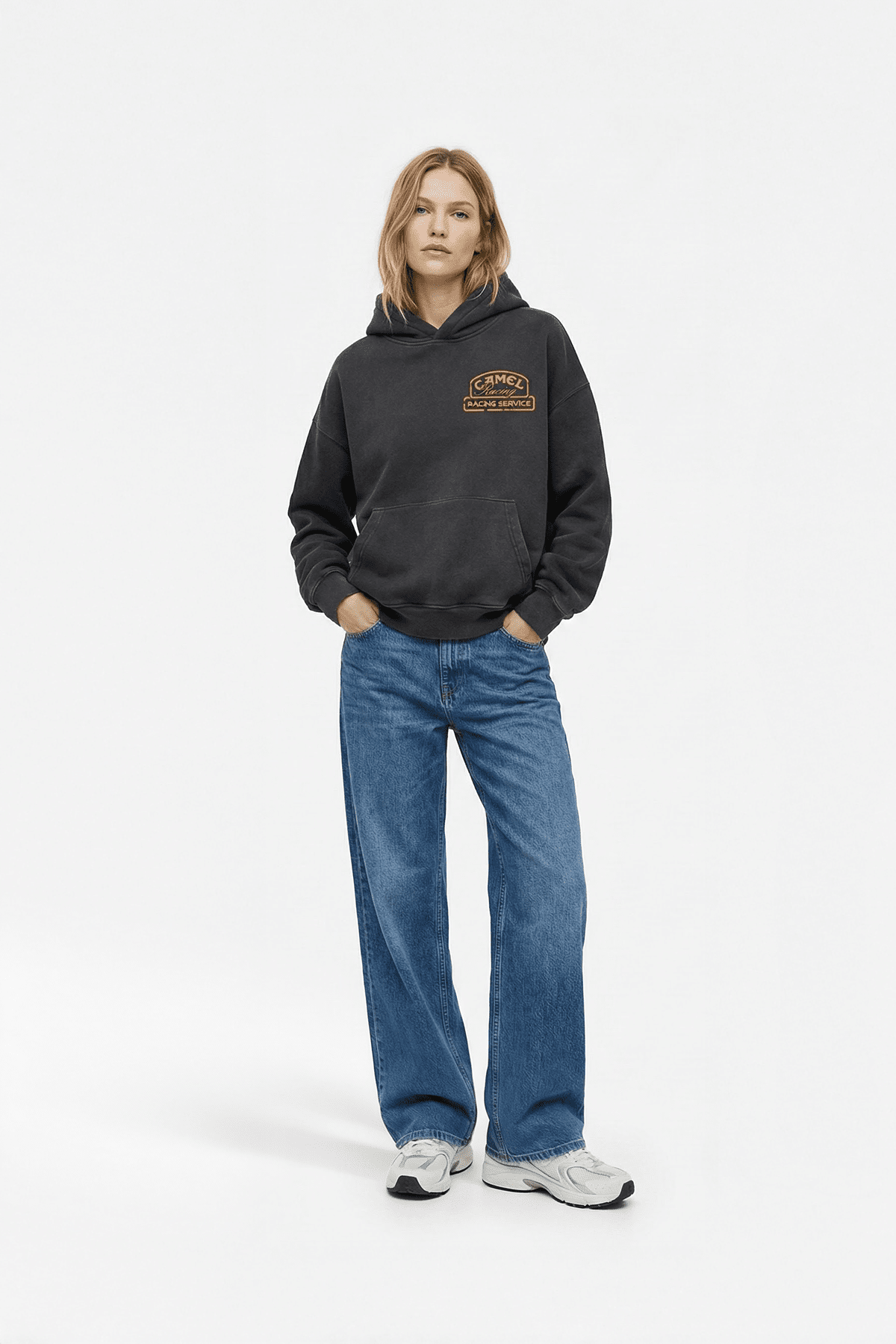 Black racing hoodie with Camel Racing Service logo, styled with wide-leg jeans and sneakers from revnhaus