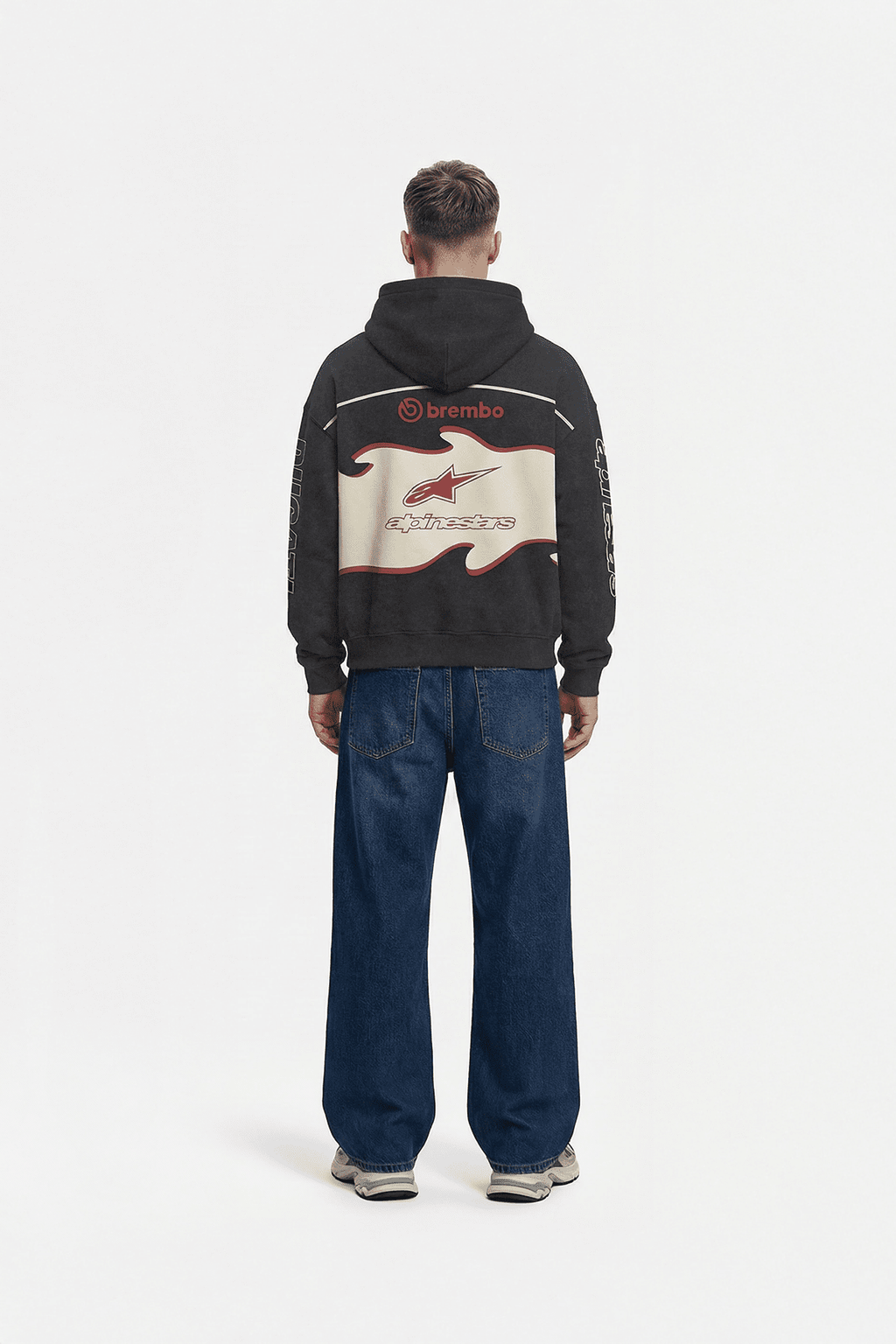 Black motorsport hoodie with Brembo and Alpinestars logos, back view from revnhaus